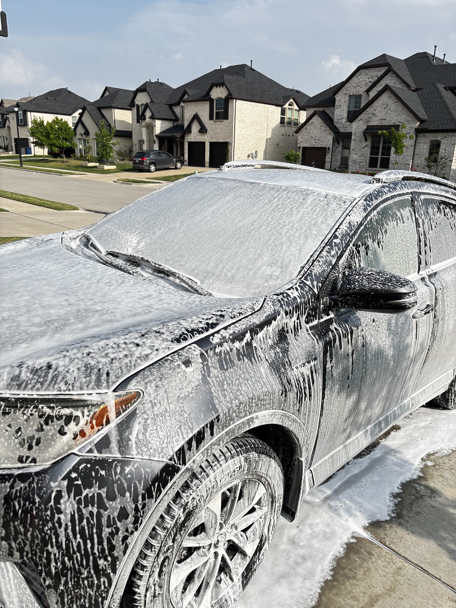 Vehicle covered in foam during an exterior hand wash.